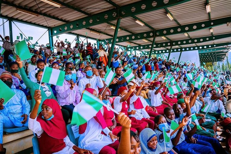 Secondary school students display the Nigerian flag as part of the 61st Independence Day celebration