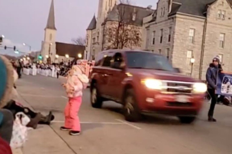 A red SUV is seen speeding through the christmas parade crowd in the city of Waukesha, Wisconsin via a video screen shot taken from the city's Facebook live streaming on November 21, 2021