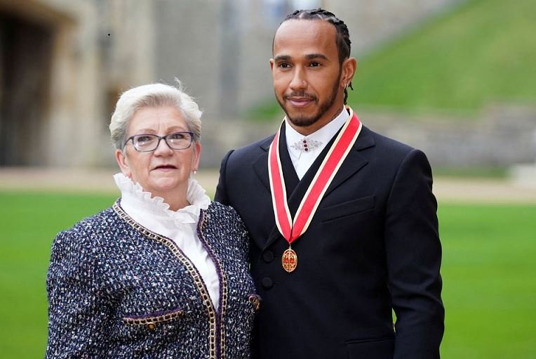 Lewis Hamilton poses with his mother Carmen Lockhart for a photo after he was made a Knight