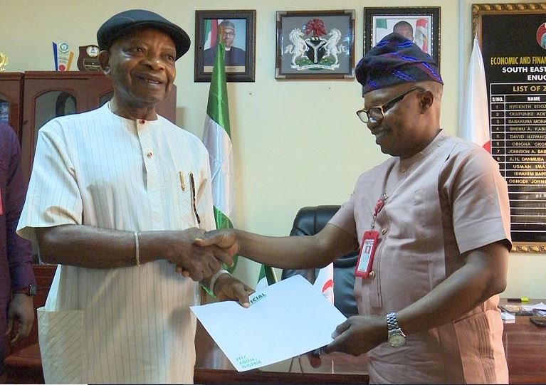 Chief Arthur Eze receiving the title of the properties from EFCC