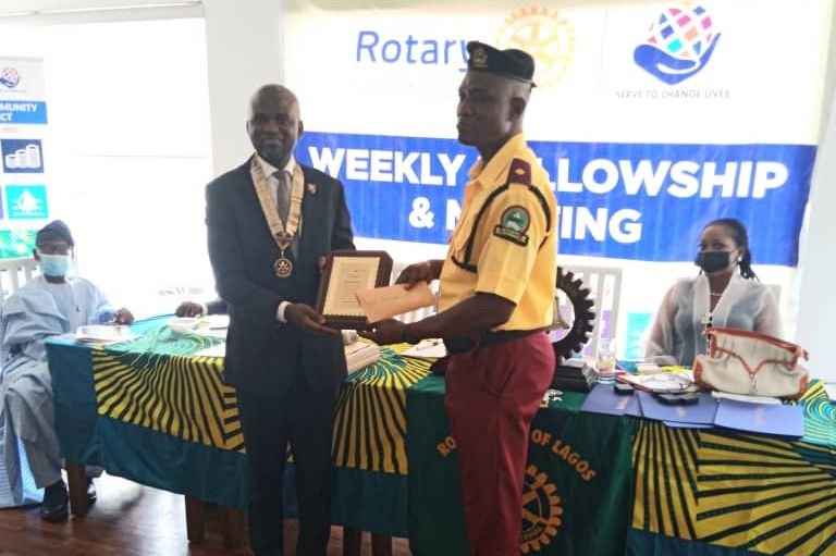 Rotary Lagos President Babawale Agbeyangi presents LASTMA officer, Abdulwahab Lawal, with the Rotary Club of Lagos Peace Award