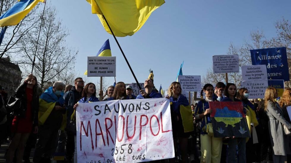 Protesters hold a placard reading “Lets save Mariupol” during a rally in support of Ukraine