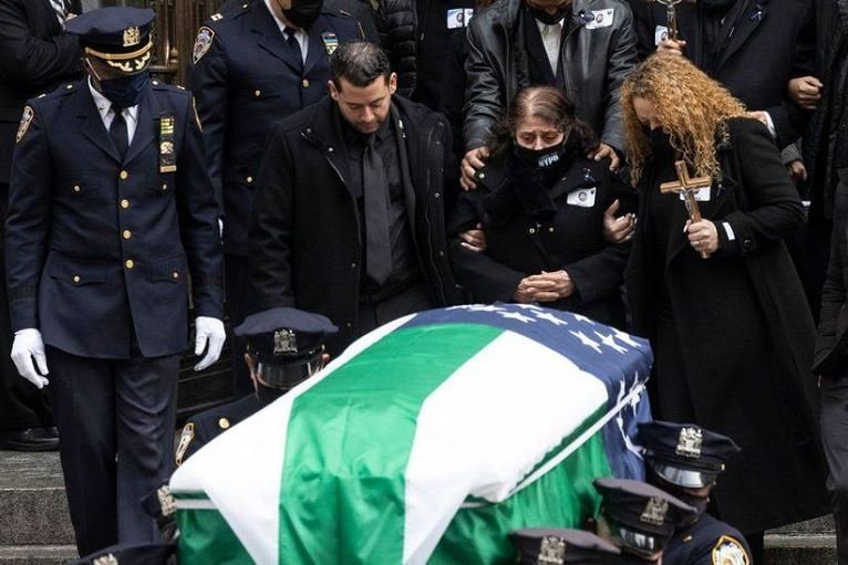 Family members at the funeral of Wilbert Mora, an NYPD officer killed by a suspect in January