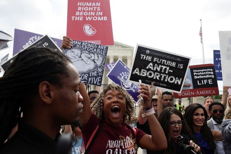 Anti-abortion demonstrators celebrate outside the United States Supreme Court as the court rules in the Dobbs v Women’s Health Organization abortion case, overturning the landmark Roe v Wade abortion decision in Washington, US, June 24, 2022 REUTERS