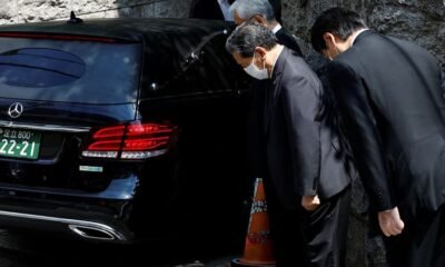 LDP officials pray to the vehicle believed to be carrying the body of former Japanese Prime Minister Shinzo Abe, who was shot while campaigning for a parliamentary election, at his residence in Tokyo, Japan