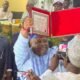 Senator Ademola Adeleke shows off the Certificate of Return