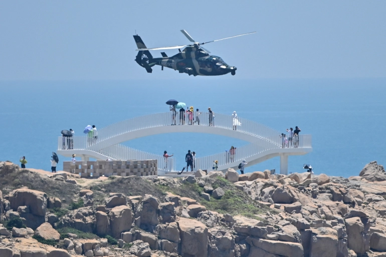 Chinese military helicopters fly past Pingtan Island, one of closest points to Taiwan in mainland China