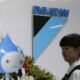 A staff walks past a logo of Daikin Industries Ltd and the company mascot Pichon at the company's office in Tokyo August 29, 2012. REUTERS
