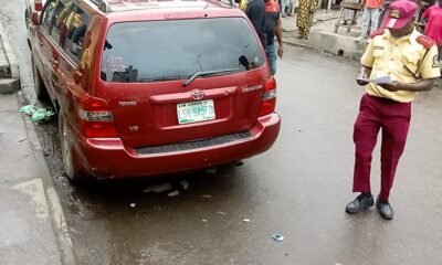 LASTMA personnel booking a vehicle parked illegally on Lagos Island