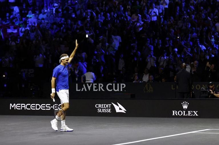 Roger Federer acknowledges cheers from the crowd as he bows out
