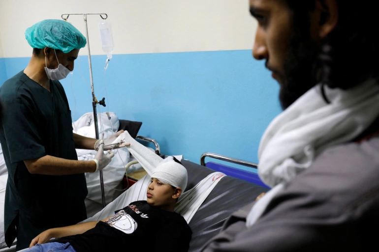 A boy who was wounded after a suicide bomber detonated explosives near the entrance of the Russian embassy is treated at a hospital in Kabul