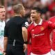 Manchester United's Cristiano Ronaldo reacts before he is shown a yellow card by referee Craig Pawson Newcastle United
