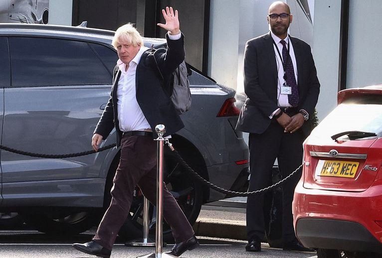 Former British Prime Minister Boris Johnson gestures, at Gatwick Airport, near London, Britain