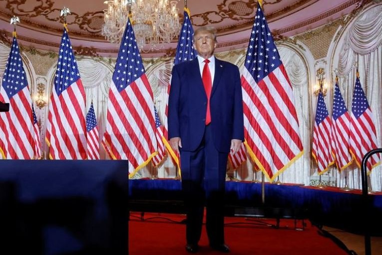 Former US President Donald Trump stands onstage listening to applause as he arrives to announce that he will once again run for US president in the 2024 US presidential election during an event at his Mar-a-Lago estate in Palm Beach, Florida, USREUTERS