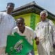 Ibrahim Akindele poses with a Glo Festival of Joy banner