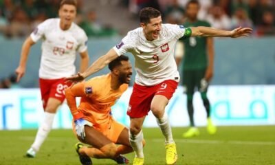 Poland's Robert Lewandowski celebrates scoring their second goal as Saudi Arabia's Mohammed Al-Owais reacts REUTERS