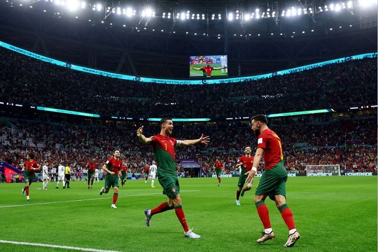 Portugal's Cristiano Ronaldo celebrates scoring their first goal with Bruno Fernandes