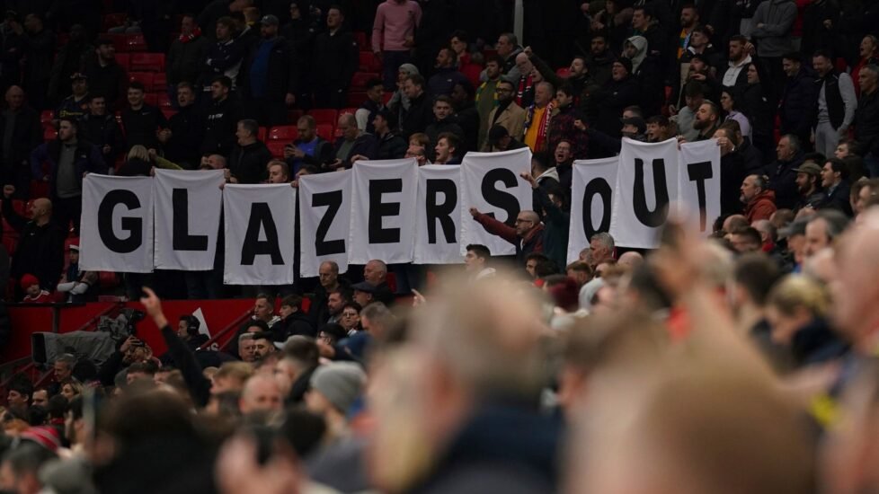 Manchester United supporters at Old Trafford hold up a banner that read 'Glazers Out' on the stands in April