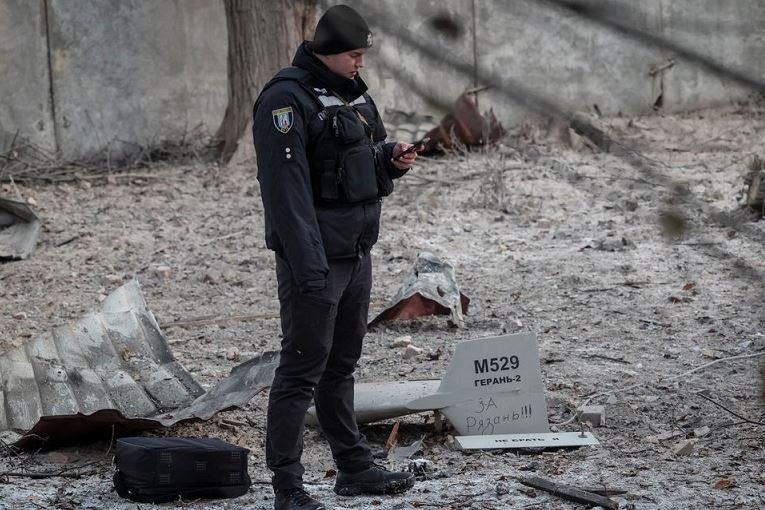 A police officer stands near parts of the drone at the site of a building destroyed by a Russian drone attack, as their attack on Ukraine continues, in Kyiv, Ukraine December 14, 2022. REUTERS