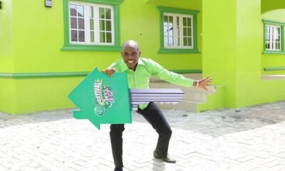 Chukwu Reuben Okorie poses with the dummy key to the Glo Festival of Joy house he won
