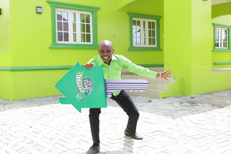 Chukwu Reuben Okorie poses with the dummy key to the Glo Festival of Joy house he won