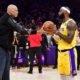 Former Los Angeles Lakers player Kareem Abdul-Jabbar hands the game ball to forward LeBron James (6) after James becomes the NBA all time scoring leader against the Oklahoma City/REUTERS