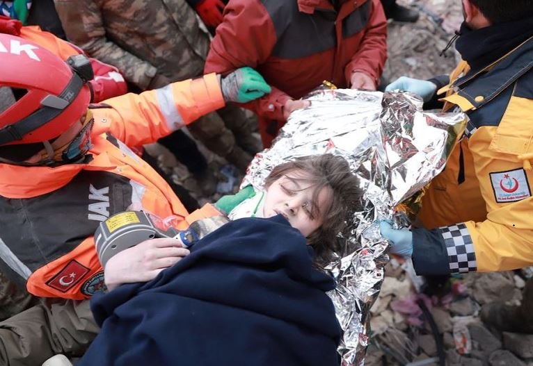 Turkish boy Poyraz is carried to an ambulance after being rescued alive from rubbles in the aftermath of a deadly earthquake in Kahramanmaras, Turkey