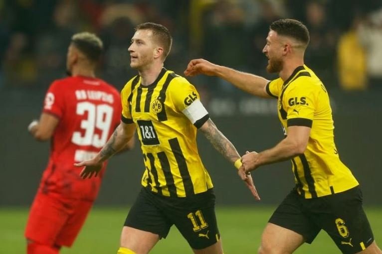 Borussia Dortmund's Marco Reus celebrates scoring their first goal with Salih Ozcan