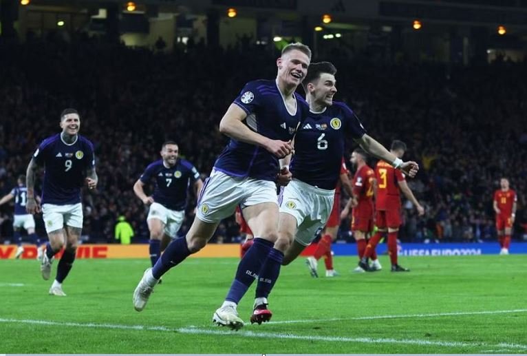 Scott McTominay celebrates scoring Scotland's first goal with teammates