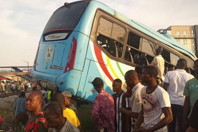 Onlookers surround the bus at the scene of the accident at PwD, Ikeja, Lagos BRT Bus