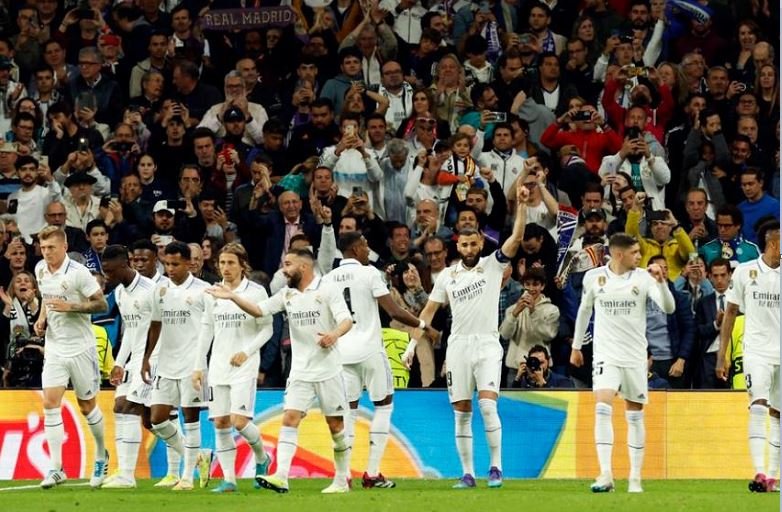 Real Madrid's Karim Benzema celebrates scoring the first goal with teammates