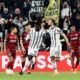 Juventus' Frederico Gatti celebrates scoring their first goal with Paul Pogba as Sevilla players look dejected