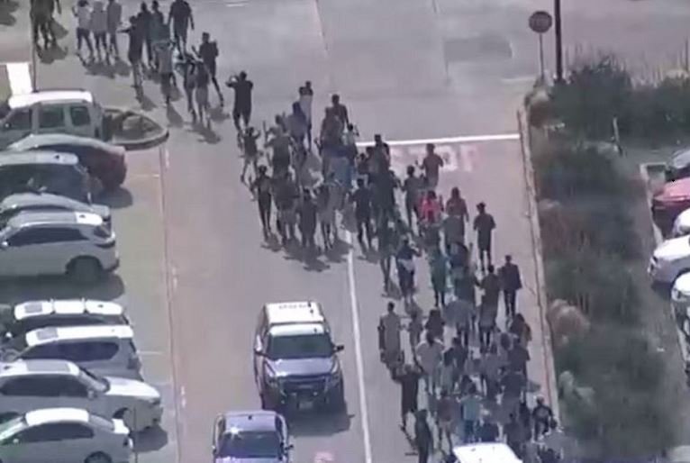 Shoppers leave with hands up as police respond to a shooting in the Dallas area's Allen Premium Outlets, which authorities said has left multiple people injured in Allen, Texas, US May 6, 2023 in a still image from video. ABC Affiliate WFAA via REUTERS