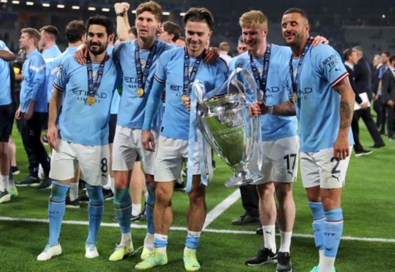 Ilkay Gundogan, John Stone, Jack Graelish, Kevin de Bruyne and Kyle Walker pose with the Champions League trophy