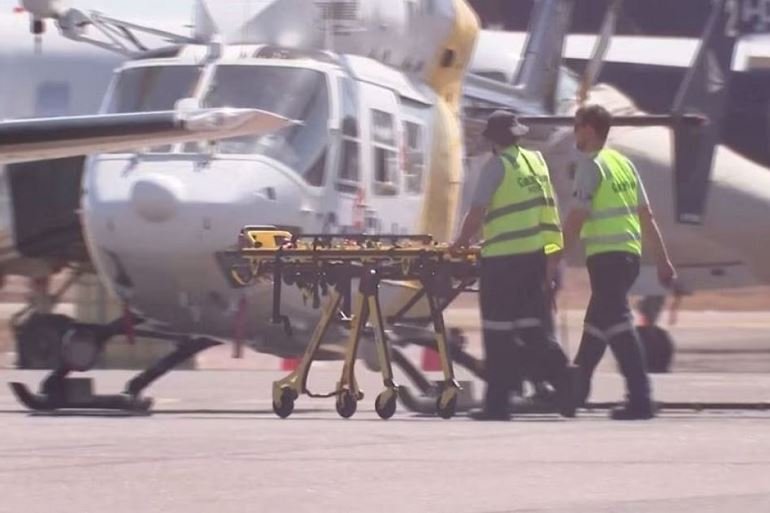 Paramedics push a stretcher following US Marines military aircraft crash in Darwin, Australia, August 27, 2023 in this screen grab obtained from a handout video. AUSTRALIAN BROADCASTING CORPORATION/via Reuters TV/Handout via REUTERS