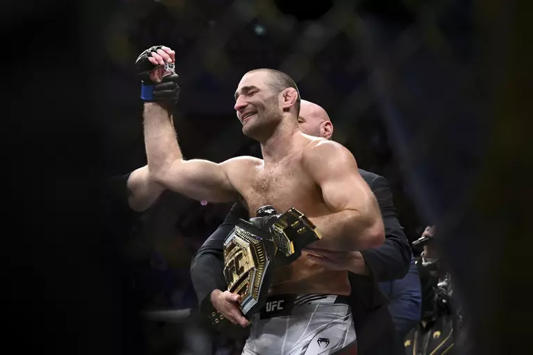 American Sean Strickland celebrates defeating Nigerian-born New Zealander zzel Adesanya to claim the midweight title by unanimous decision in the main event of UFC 291 in Sydney Sunday Sept. 10, 2023, (Dan Himbrechts/AAP image via AP)