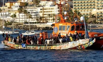A group of migrants in a wooden boat are towed by a Spanish coast guard vessel to the port of Arguineguin, in the island of Gran Canaria, Spain, October 21, 2023. REUTERS/Borja Suarez Acquire Licensing Rights Canary Islands