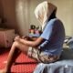 Same-sex Jane, 39, a Nigerian lesbian, sits on her bed in her apartment in Makurdi, Benue state, Nigeria December 29, 2023. REUTERS/Abraham Achirga