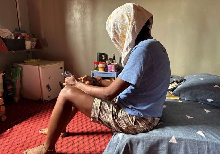 Same-sex Jane, 39, a Nigerian lesbian, sits on her bed in her apartment in Makurdi, Benue state, Nigeria December 29, 2023. REUTERS/Abraham Achirga