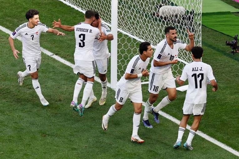 Iraq players celebrate scoring against Japan in the Asian Cup