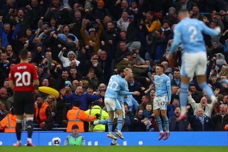 Manchester City's Phil Foden and Bernardo Silva celebrate Erling Haaland's winner against Manchester United at the Etihad Stadium