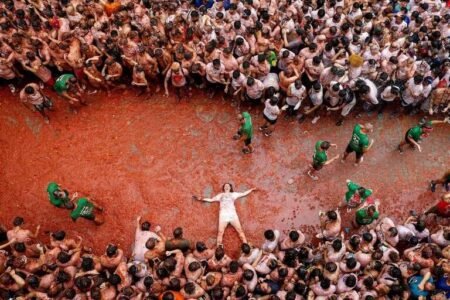 Spanish town gets soaked in red during tomato-lobbing Tomatina festival
