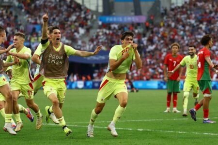 Spain players celebrate after the final whistle against Morocco