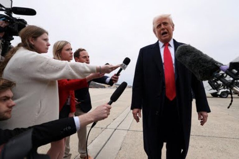 Reporters microphone strikes Trump at press briefing