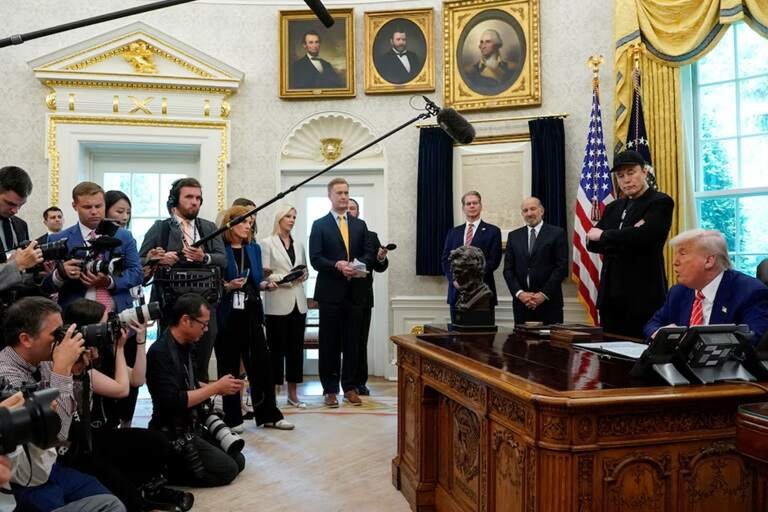 Elon Musk stand next to President Donald Trump during a press conference in the Oval Office at the White House on May 30, 2025