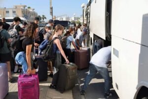 Passengers from the Crown Iris, a cruise ship, board buses at the port of Larnaca, Cyprus, June 18, 2025. REUTERS Iran