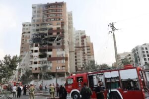 Firefighters work at the scene of a damaged building in the aftermath of Israeli strikes, in Tehran, Iran, June 13, 2025. Majid Asgaripour/WANA (West Asia News Agency) via REUTERS